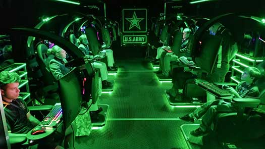 Visitors play video games inside a semitrailer belonging to the U.S. Army Recruiting Command's esports team during the Association of the U.S. Army's Annual Meeting and Exposition in Washington, D.C, Oct. 14, 2019. The command plans to create a cyber esports team and roll out autonomous recruiting operations, which will increase the mobility of recruiters with a larger social media presence. (Sean Kimmons)