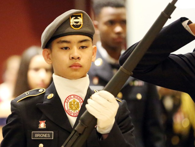Cadet Pfc. Brian Briones, a member of the Zama Middle High School Junior Reserve Officers’ Training Corps, holds a rifle as a member of the color guard during the Trojan Battalion’s 2020 Cadet Ball at Club Trilogy, Naval Air Facility Atsugi, Japan, Feb. 29, 2020. - Photo DOD